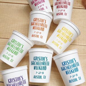 May include: A set of white plastic cups with the text "Kristin's Bachelorette Weekend 7-27-18 Austin, TX" printed on them in various colors.