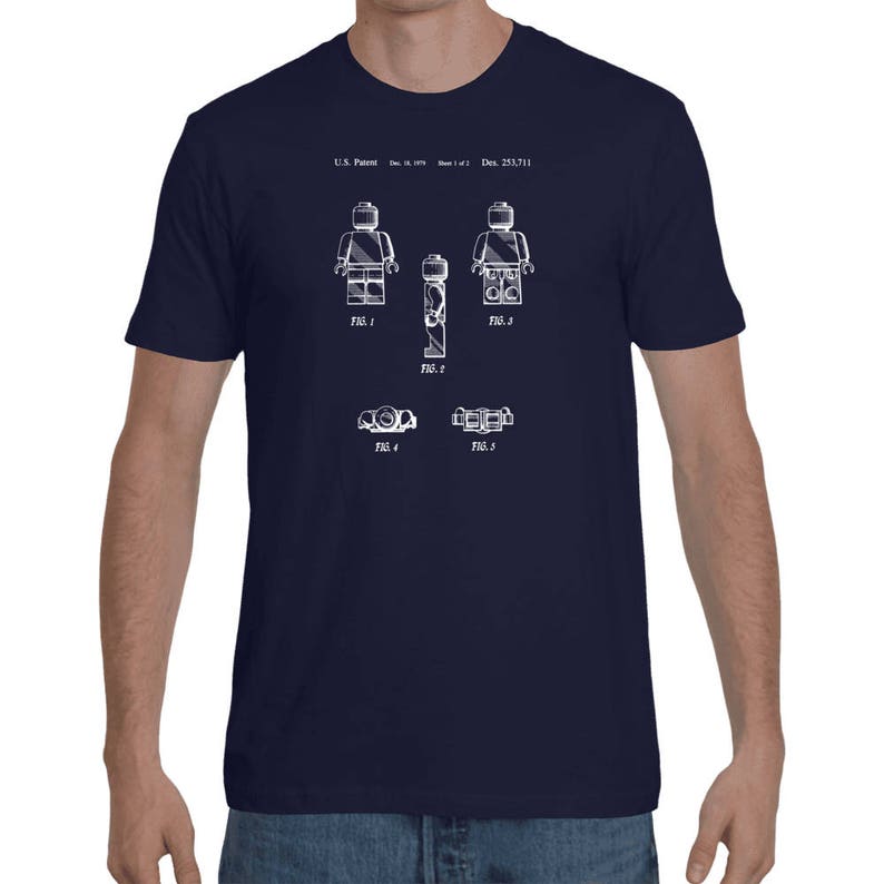 May include: A navy blue t-shirt with a white print of a Lego figure patent design. The design includes the text "U.S. Patent" and "Des. 253,711".