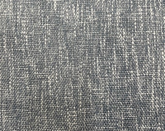 May include: Close-up of a grey textured fabric with a subtle white pattern. The fabric has a woven appearance.