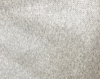 May include: Close-up of a gray textured fabric with a subtle woven pattern.