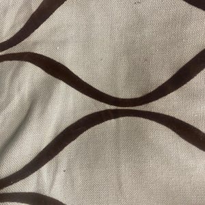 May include: A light gray fabric featuring a repeating pattern of dark brown velvet-like curved lines. The texture of the base material appears woven, while the dark brown lines create a series of interconnected wave shapes across the surface.