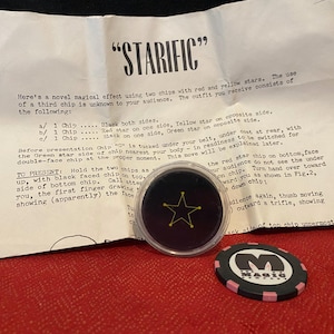 May include: A black and pink casino chip with the word "MAGIC" and a star-shaped design. A clear plastic container with a black chip and a yellow star design. A folded paper with the word "STARIFIC" and instructions.