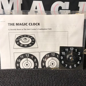 May include: A black and white illustration of a combination clock with the text "THE MAGIC CLOCK" and "Secretly Know as The Safe Cracker's Combination Clock".