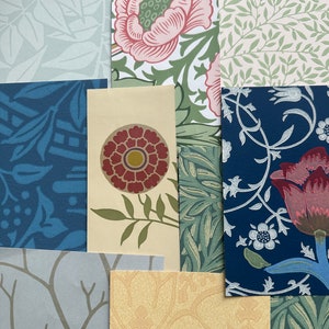 Op de afbeelding: Een verzameling behangstalen met patronen in verschillende kleuren en ontwerpen. De stalen bevatten bloemen-, blad- en geometrische patronen in tinten blauw, groen, roze en beige. De opstelling toont een verscheidenheid aan texturen en stijlen.