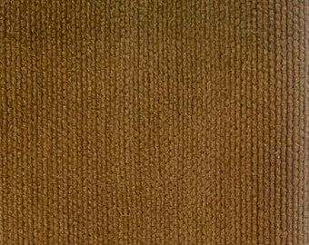 May include: Close-up of a brown corduroy fabric with a vertical ribbed texture.