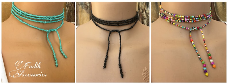 May include: Three beaded choker necklaces with adjustable ties. The first necklace is turquoise blue, the second is black, and the third is multi-coloured.
