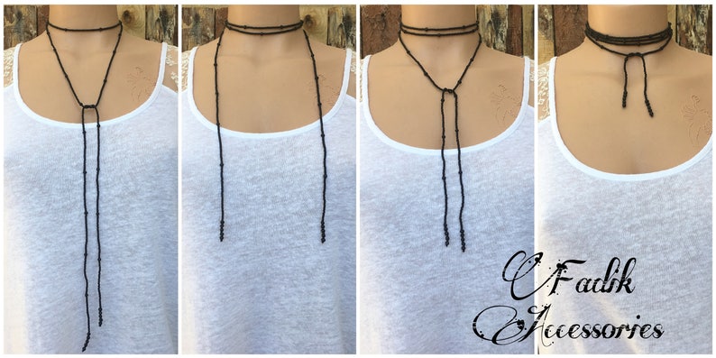 May include: A black beaded choker necklace with long, dangling strands. The necklace is shown on a model wearing a white vest top.