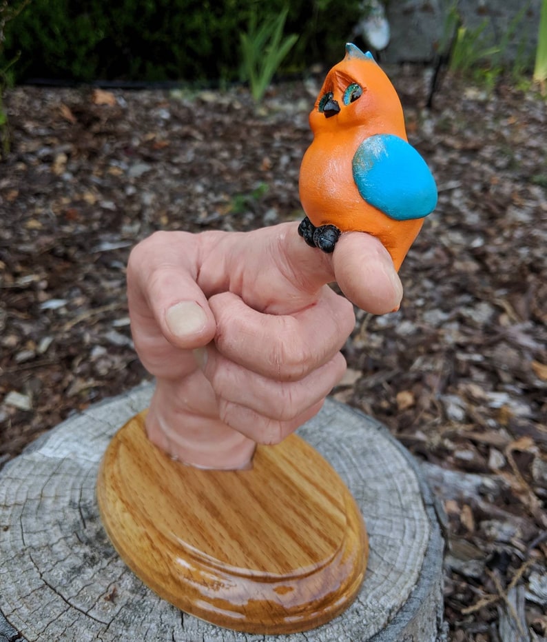 Realistic hand with a cartoonish aNGie Bird handmade sculpture OOAK on wooden oak base