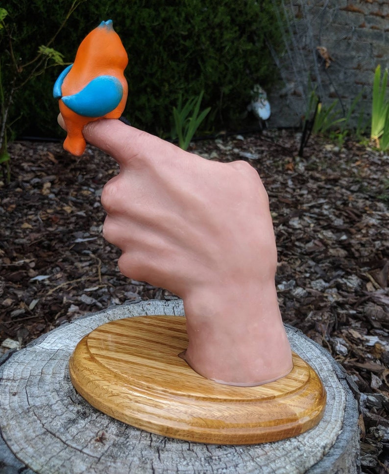 Realistic hand with a cartoonish aNGie Bird handmade sculpture OOAK on wooden oak base