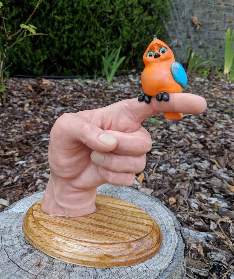 Realistic hand with a cartoonish aNGie Bird handmade sculpture OOAK on wooden oak base