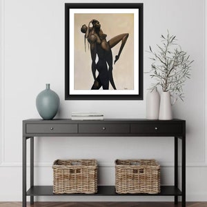 May include: A framed painting of a couple embracing. The man is holding the woman in his arms, and they are both looking up. The painting is done in a realistic style, with muted tones of brown and beige.