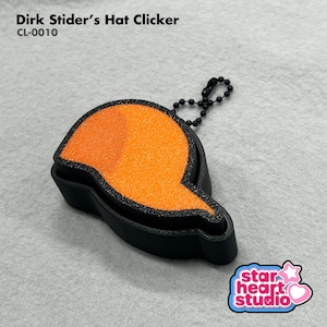 May include: A Dirk Strider's Hat Clicker, model CL-0010, featuring a black base and a textured orange cap-shaped top. The object includes a small black ball chain attached to the side for hanging. The text Dirk Strider's Hat Clicker CL-0010 is visible.