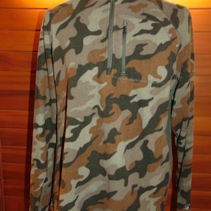 May include: A camouflage-patterned fleece pullover with a quarter-zip closure and a zippered pocket on the left side.