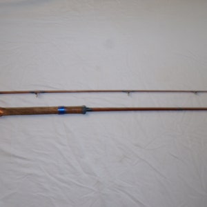 May include: A two-piece wooden fishing rod with a blue and copper colored handle.
