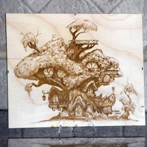 May include: A wood-burned image of a treehouse with multiple levels and windows. The treehouse is surrounded by trees and has a sign that reads "Fairy Circle".