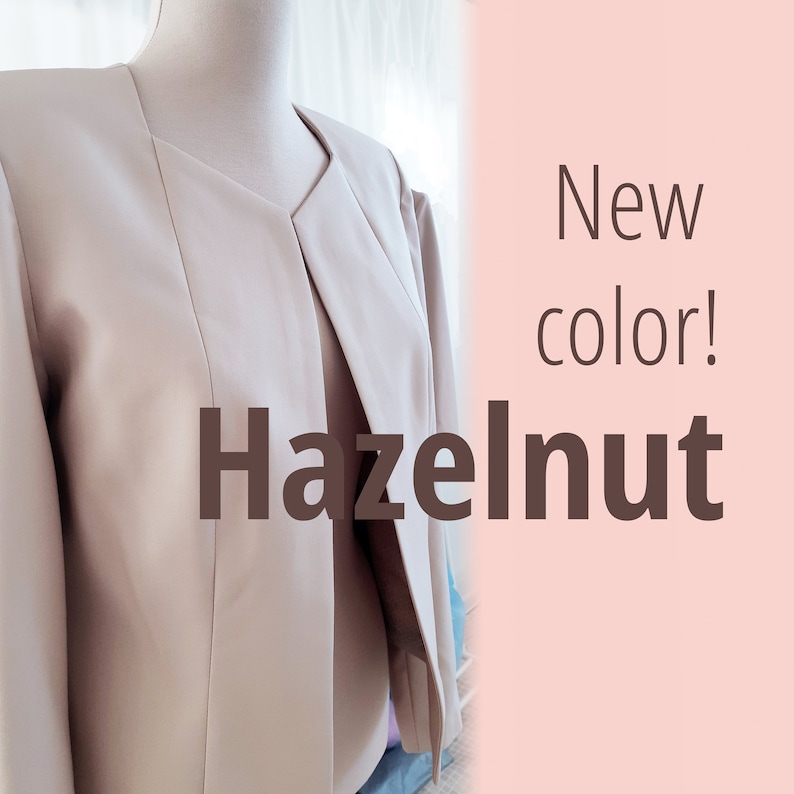 May include: A light beige blazer with a v-neck and a long, open front. The text "New color! Hazelnut" is displayed on a pink background.