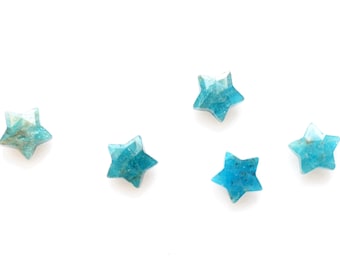 May include: Five blue star-shaped crystals on a white background.