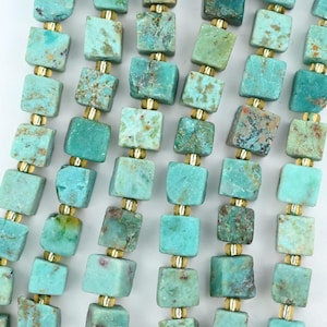May include: A strand of square-shaped turquoise beads alternating with small, round, metallic gold-colored spacer beads. The turquoise beads feature natural variations in blue and green hues with brown matrix inclusions throughout the stone surfaces.