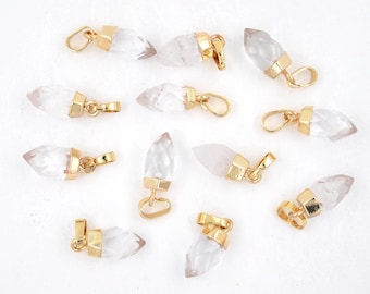 May include: Twelve gold-plated crystal point pendants with a clear, faceted design. Each pendant has a gold bail for attaching to a chain or cord.