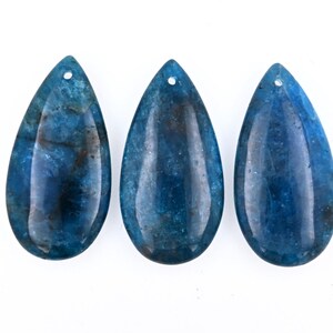 May include: Three teardrop-shaped blue agate pendants with a hole at the top for stringing.