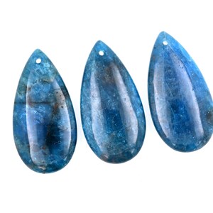 May include: Three teardrop-shaped blue gemstone pendants with a hole at the top for stringing.