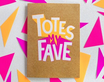 May include: A brown card with the text "Totes My Fave" in white letters with a pink and yellow background.