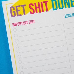May include: A white printable to-do list with the text "GET SHIT DONE" in yellow, pink, and blue. The list is divided into two sections: "IMPORTANT SHIT" and "LESS IMPORTANT SHIT".