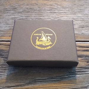 May include: A brown box with a gold foil logo that says "JORVIK WOOD HANDMADE IN YORK" and features a Viking ship.