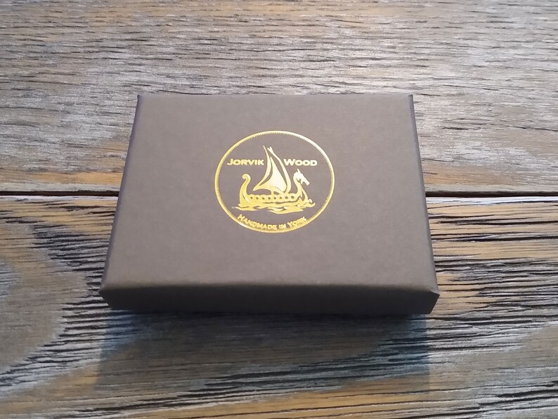 May include: A brown box with a gold foil logo that says "JORVIK WOOD HANDMADE IN YORK" and features a Viking ship.
