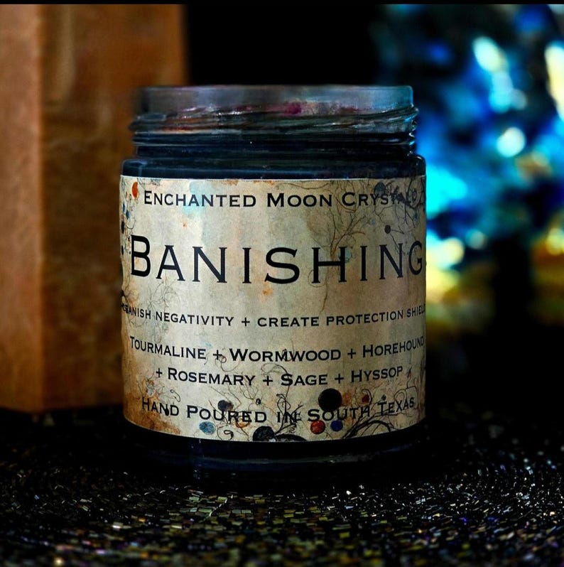 Handmade Banishing intention candle in a clear glass jar with dark wax and a vintage-style label. This spiritual candle is created for banishing unwanted energy, energetic clearing, cutting cords and reclaiming your space with protection and intention.
