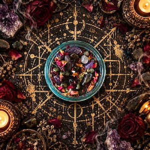 Overhead photograph of the Someone Fucked Up crystal candle surrounded by an intricate golden geometric ritual star, dried burgundy roses, purple amethyst clusters, and glowing candlelight. The turquoise glass jar reveals dark wax decorated with polished stones, colorful flower petals, and herbs. A richly detailed witchcraft altar scene inspired by black magic, spiritual protection, and ritual intention candles.