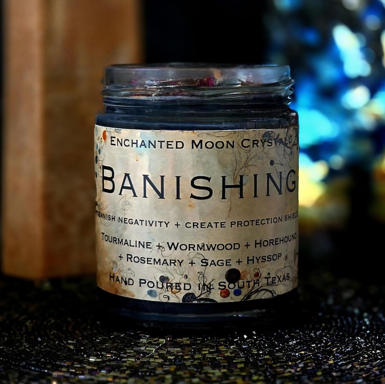 Handmade dark wax Banishing candle in a glass jar with a distressed vintage-style label. Created as a spiritual intention candle for banishing, energetic purification, removing unwanted attachments, cord cutting and protective ritual work.