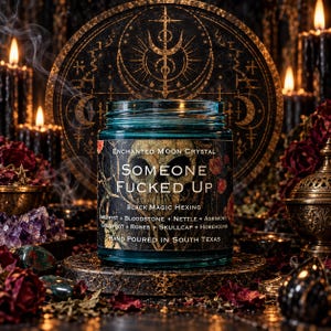 Someone Fucked Up black magic candle photographed against an ornate golden occult altar backdrop with circular mystical symbols, flickering black candles, dried roses, amethyst crystals, and curling smoke. The turquoise glass jar and dark gothic label stand out against the warm amber lighting. A dramatic handcrafted ritual candle designed around themes of energetic boundaries, banishment, and reclaiming power.