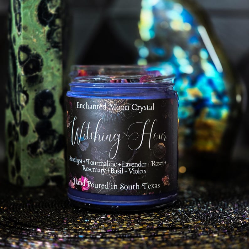 Mystical Witching Hour candle handcrafted for meditation, intuition and spiritual practice with crystals, herbs and flowers over purple wax.