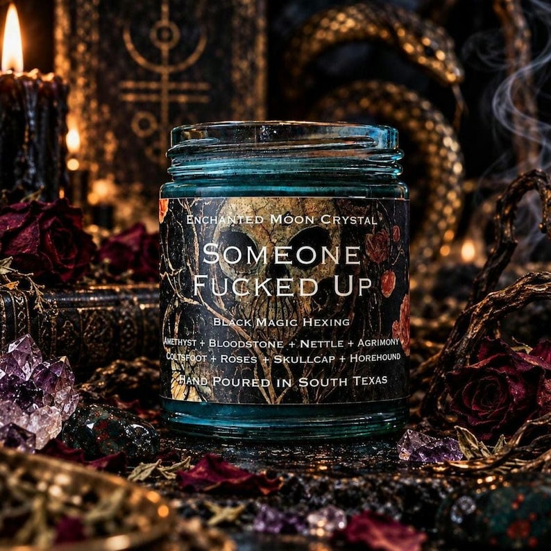 Someone Fucked Up black magic intention candle by Enchanted Moon Crystal, featuring a turquoise glass jar with a dark gothic label. Displayed on an elaborate witchcraft altar surrounded by amethyst crystals, dried burgundy roses, golden occult decorations, and curling incense smoke. A dramatic ritual candle inspired by hexing, banishing, energetic protection, and reclaiming personal power.