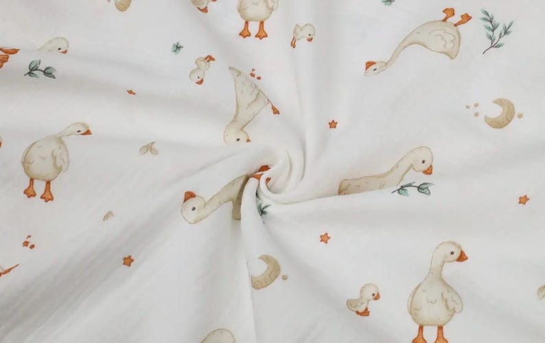 May include: White fabric with a repeating pattern of watercolor geese in various poses, along with stars, moons, and sprigs of greenery. The geese are beige with orange beaks and feet. A soft, whimsical design.