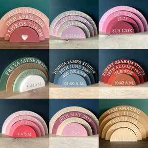 May include: A set of nine wooden rainbow arches with personalized details, including names, dates, weights, and times. The arches are painted in various colors, including pink, green, blue, brown, and beige. Each arch has a different inscription, such as "Amelia Rita Jane 12th April 2024 3.545KGS 7:14 PM" and "I am Amazing I am Clever I am Brave I am Loved I am Kind".