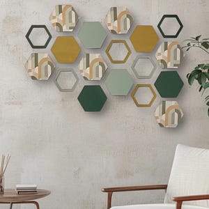May include: A wall decor set of 16 hexagonal shaped wall art pieces in shades of green, brown, and gold. The pieces are arranged in a honeycomb pattern.