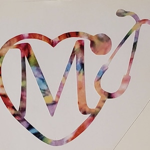 May include: A colorful heart-shaped design with the letter "M" inside and a stethoscope on the right side. The design is in a tie-dye pattern with shades of pink, blue, yellow, and green.