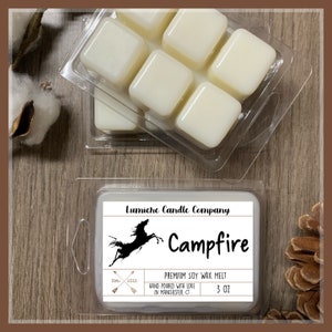 May include: A white wax melt with a black silhouette of a horse and the text "Campfire" on a white label. The label also includes the text "Lumiche Candle Company", "Est. 2015", "Premium Soy Wax Melt", "Hand Poured with Love in Manchester, CT", and "3 oz".