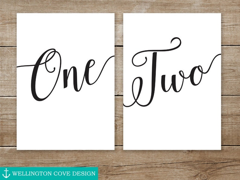 May include: Two printable signs with the words "One" and "Two" written in a cursive font.