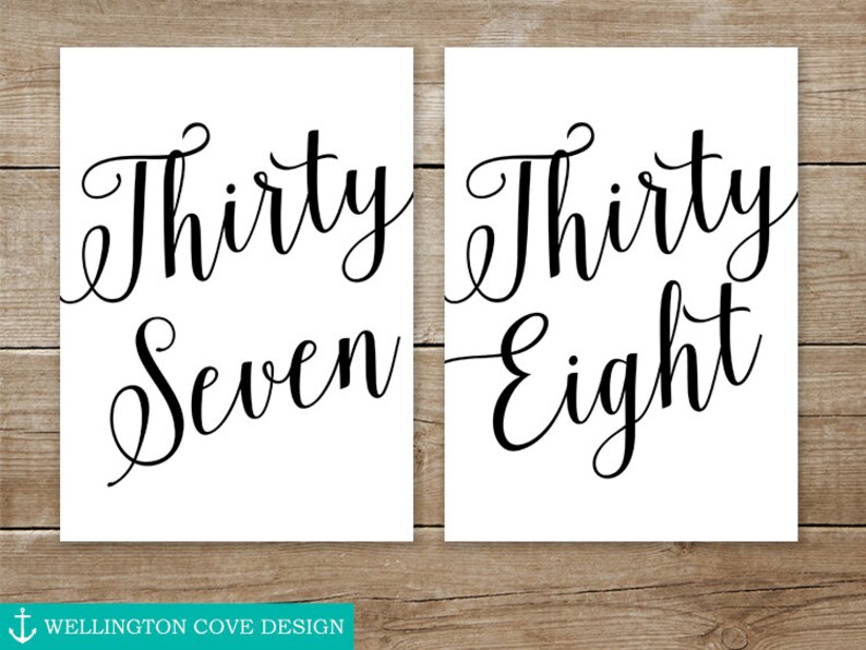 May include: Two white signs with black calligraphy. The first sign says "Thirty Seven" and the second sign says "Thirty Eight".