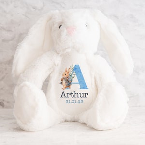 May include: White plush bunny with a blue and watercolor floral letter A and the name Arthur and the date 31.01.23 printed on the chest.