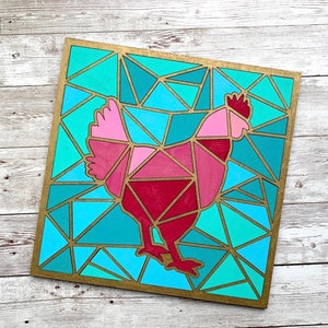 May include: A geometric mosaic design of a pink and red chicken on a blue and green background. The design is framed in gold.