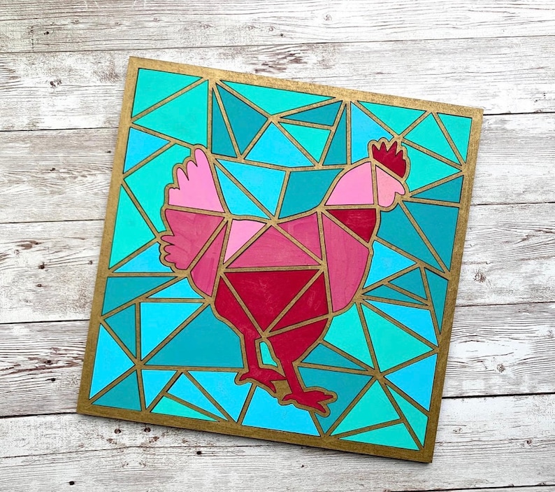 May include: A geometric mosaic design of a pink and red chicken on a blue and green background. The design is framed in gold.