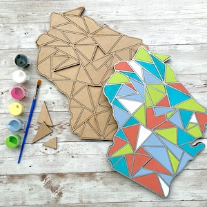 May include: A wooden craft project featuring a geometric design of a state outline. The outline is painted in shades of blue, green, red, and white. The project includes paint, a paintbrush, and extra pieces of wood.