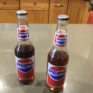 1980s Pepsi Long Neck bottles sealed caps-12 oz unopen-some evaporation of contents-glass soda pop cola bottles Pepsi collectors memorabilia