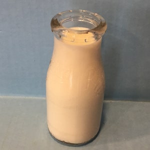 Rishers Dairy half pint milk bottle 1940/1950 registered sealed-clear glass-round lip frigratr container-pink hue-Rishers Dairy on each side