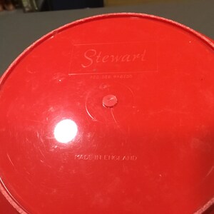 May include: Red plastic bowl with the text "Stewart" and "Reg. Des. 846703" on the bottom. The bowl also says "Made in England".