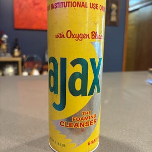 May include: A vintage yellow Ajax The Foaming Cleanser can with green and silver text. The can reads "For Institutional Use Only" and "with Oxygen Bleach". The net weight is 1 lb. 5 oz.